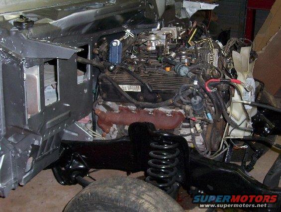 vehicle engine and chassis with suspension components visible