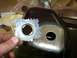 1992 Lincoln Custom - A hand holds a metal part with a hole over a section of a dark vehicle body that also has a hole.