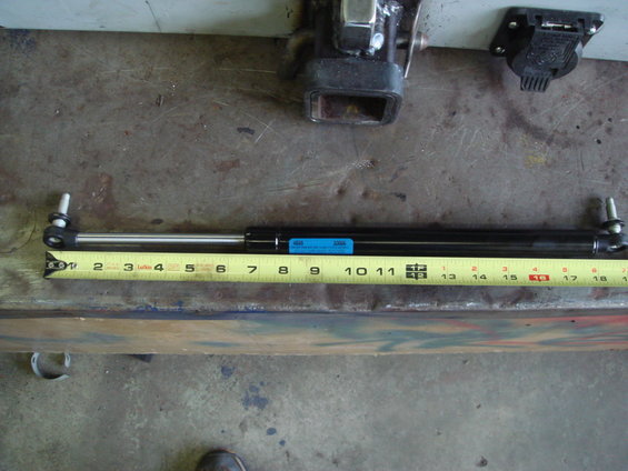 Gas strut measured at 10 inches on a yellow tape measure