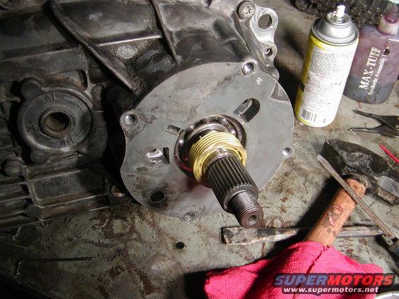 Transmission output shaft with bearing and housing. Tools and spray cans nearby