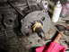 1991 Ford Bronco - Close-up of a transmission output shaft assembly, with tools and lubricants visible on the workbench.