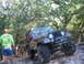 1996 Ford Bronco - A Jeep CJ-7 navigates a rocky, wooded trail during an off-road excursion.