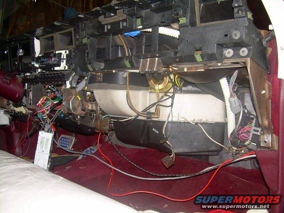 Heater core assembly with exposed wiring and red carpet