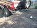 1996 Ford Bronco - The rear of a maroon Ford Bronco is visible, with a spare tire mounted on the back and a Texas license plate.