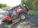 1996 Ford Bronco - A red Jeep Wrangler navigates a rocky, off-road trail with other vehicles visible in the distance.