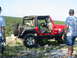 1996 Ford Bronco - A red Jeep Wrangler is parked on a rocky hill with two men standing nearby.