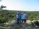 1996 Ford Bronco - A family poses for a photo on a rocky hill overlooking a vast expanse of trees under a clear blue sky.
