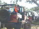 1996 Ford Bronco - Multiple Jeeps are seen on an off-road trail, with one orange Jeep in the foreground.