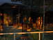 1996 Ford Bronco - A rustic scene a building with a well and benches, illuminated by the setting sun.
