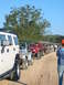 1996 Ford Bronco - A convoy of Jeeps drives down a dusty road, with a large white SUV leading the way.
