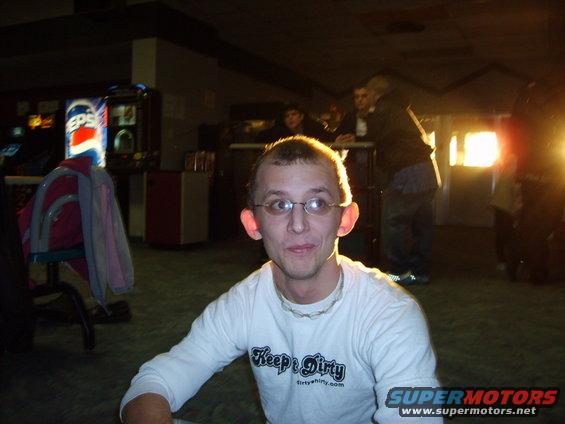 Man with glasses and a white t-shirt that says "Keep it Dirty"