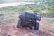 1995 Ford Bronco - Ford Bronco navigates a steep dirt incline in a rural landscape.