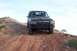 1995 Ford Bronco - A black 1995 Ford Bronco is parked on a dirt hill under a clear sky.