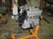 1996 Ford Probe - Engine on a stand in a workshop, with tools and boxes nearby.