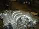1996 Ford Probe - A close-up view of a Mazda KL-DE V6 engine, likely removed from a vehicle for repair or replacement.