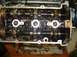 1996 Ford Probe - Close-up view of an engine's internal components, including camshafts and gears, with the valve cover removed.