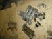 1996 Ford Probe - Disassembled engine parts including intake manifold and valve cover laid out on cardboard.