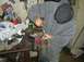 1996 Ford Probe - A person works on a metal component secured in a vise, surrounded by tools and automotive supplies in a workshop setting that appears to be…