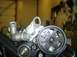 1996 Ford Probe - Close-up view of engine components, including a pulley, belt, and hoses.