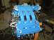 1996 Ford Probe - A freshly painted blue Mazda V6 engine is mounted on an engine stand, ready for installation.
