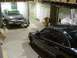 1992 Ford Crown Victoria - Two sedans are parked in a garage, one on a lift and the other in the foreground.