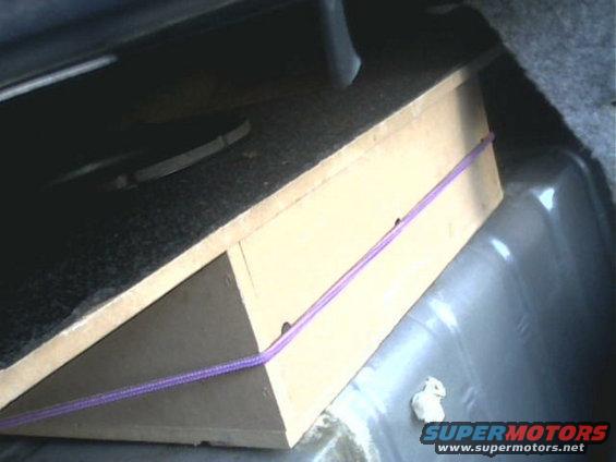 image46.jpg When carpet is over it the sub is hidden making it look like its not there. And yes that a bungie cable holding it in place(Hey it does the job, not like I can drill holes there, kinda a gas tank under it).