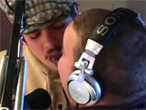 Two people in a recording studio with headphones and a microphone