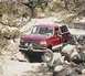 1993 Ford Bronco - This red 1993 Ford Bronco is shown off-roading on a rocky trail.