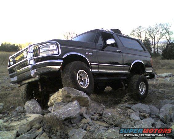 Black Ford Bronco with lifted suspension and off-road tires on a rocky terrain