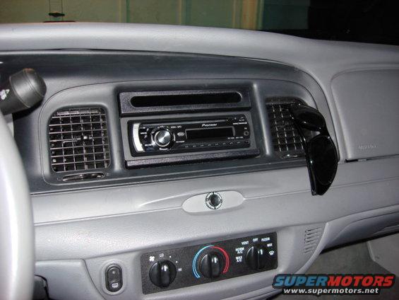 2003 Ford Crown Victoria interior showing dashboard, Pioneer radio, and air vents with sunglasses hanging