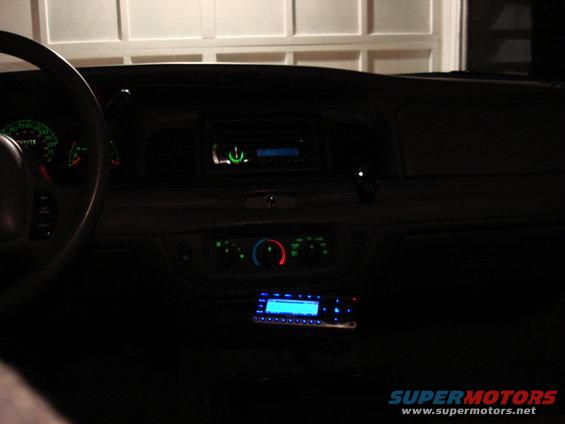 2003 Ford Crown Victoria interior showing dashboard, steering wheel, and two radios