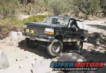 1993 Ford Bronco driving on a rocky trail