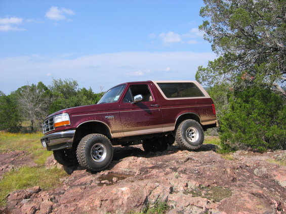 Maroon 1996 Ford Bronco on rocky terrain, side view