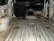 1978 Ford Bronco - The interior of the vehicle is stripped down, revealing the ribbed metal floor and dashboard.