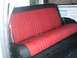 1978 Ford Bronco - The interior features a red and black upholstered rear seat with visible seatbelts and black carpeting.