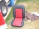 1978 Ford Bronco - Car seat with red and black upholstery, part of a vehicle restoration project.