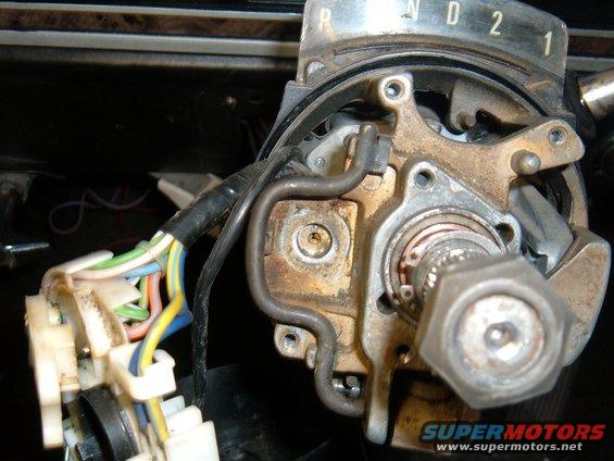 Close-up of steering column mechanism with wiring harness and gear indicator