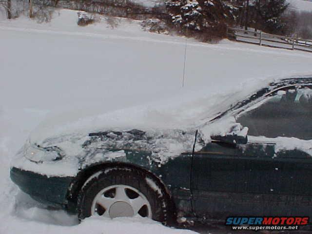 Partially cleaned to show how high snow was on the car.