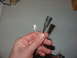 1988 Ford Bronco - Hand holds a female spade connector and a black rubber boot for an electrical connector.