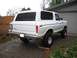 1979 Ford Bronco - This white Ford Bronco is parked in a driveway with a garage in the background.
