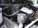 1978 Ford Bronco - Close-up view of the brake booster and master cylinder assembly within a vehicle's engine compartment.