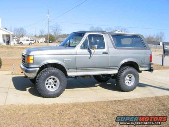 1989 Ford Bronco lifted with large tires, side view