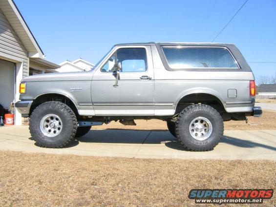 Silver 1989 Ford Bronco side view with large tires