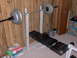 1996 Chevrolet Cavalier - A weight bench setup with a barbell loaded with weights is shown in a room with wood-paneled walls.