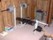 1996 Chevrolet Cavalier - A weight bench setup is shown with a barbell and various weight plates, along with other exercise equipment.