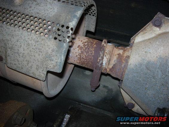 close-up of rusted exhaust pipe and heat shield