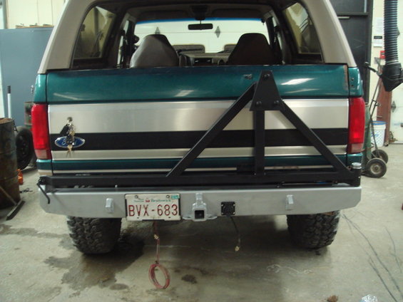 Rear view of a 1996 Ford Bronco with a custom spare tire carrier and aftermarket bumper. License plate BVX-683 is visible