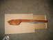 1995 Ford C-350 (Centurion Conversions) - Overhead console trim piece with wood-grain finish, placed on cardboard.