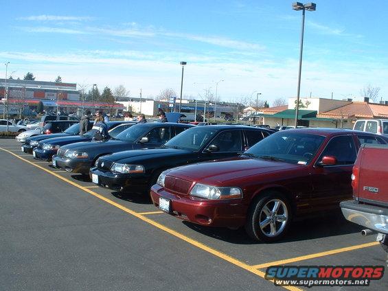 Red 2000 Ford Crown Victoria parked in a lot with other similar cars