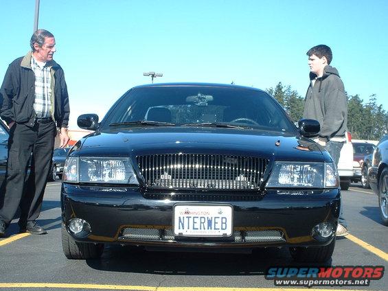Black 2000 Ford Crown Victoria front view with chrome grille and Washington license plate NTERWEB